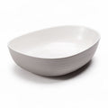 Tigela oval em cerâmica branca com dimensões de 25 x 20 x 7cm